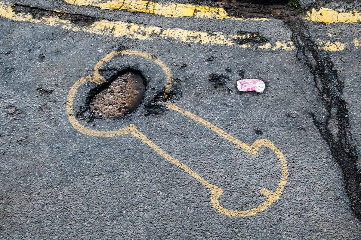 , pothole; A cocky artist has highlighted the town’s potholes by drawing large penises